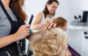 A resident having a hair cut.